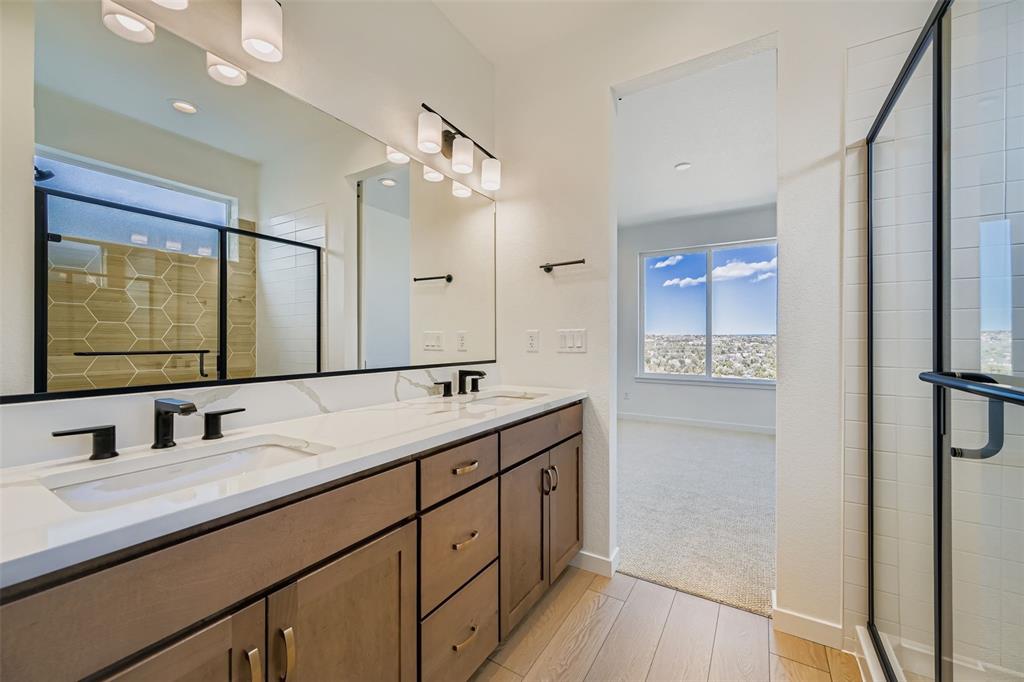 Image 11 of 13: Bathroom featuring plenty of natural light, light wood-style flooring, doub