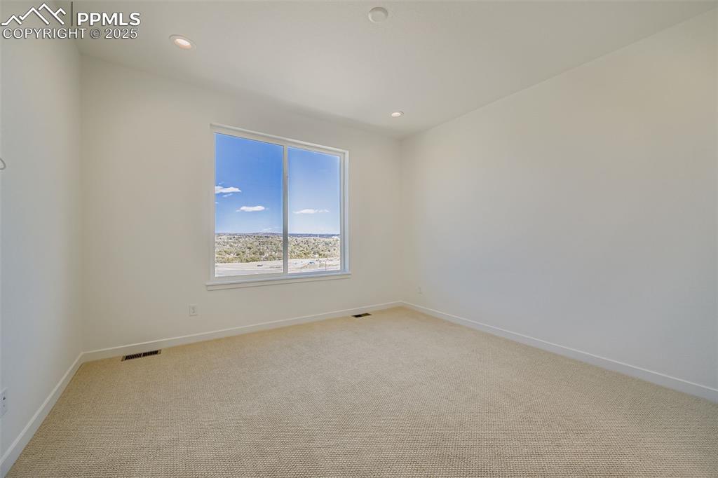 Image 14 of 21: Unfurnished room with light carpet and recessed lighting