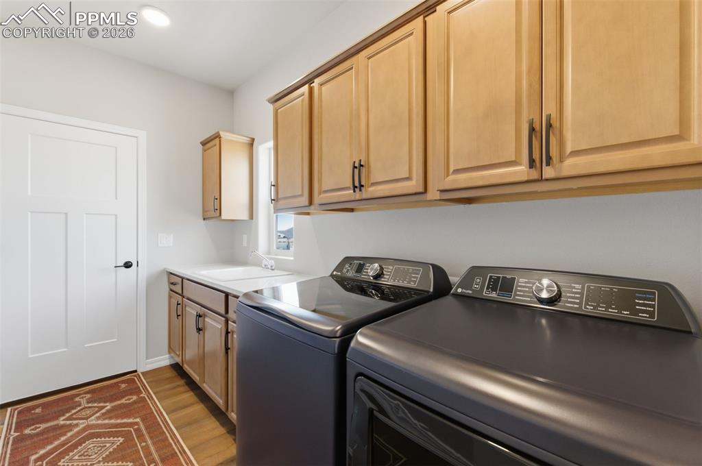 Image 19 of 44: Notice All The Cabinet Space & Double Sink In The Main Level Laundry Room