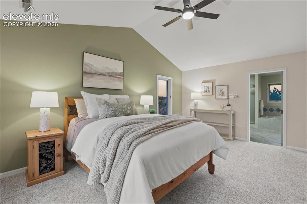 Image 12 of 48: Vaulted ceiling with a ceiling fan, carpeted flooring, and an open doorway 