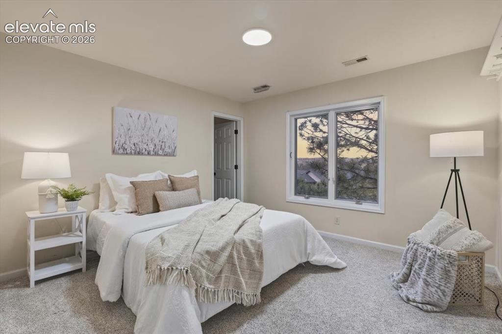 Image 16 of 48: Neutral-toned walls complement the light gray carpeting