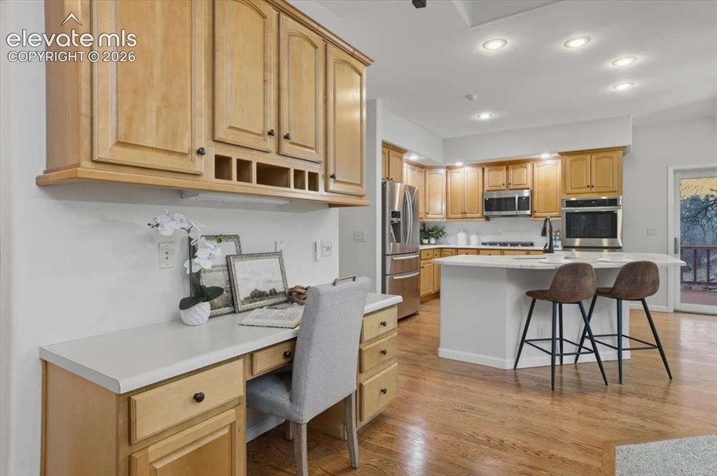 Image 27 of 48: Built-in desk area with wood cabinetry