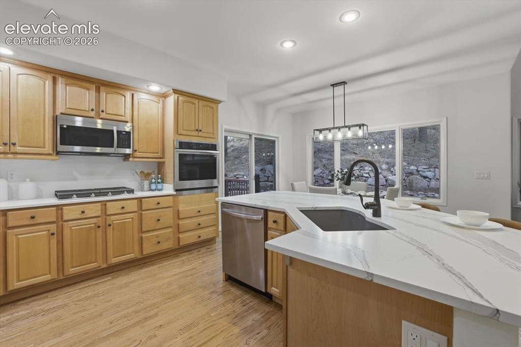 Image 4 of 48: Kitchen featuring wood- flooring, light wood flooring,stainless st Quartz c