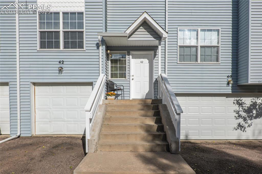 Image 2 of 25: Inviting front entry, one car garage and parking in front of garage.