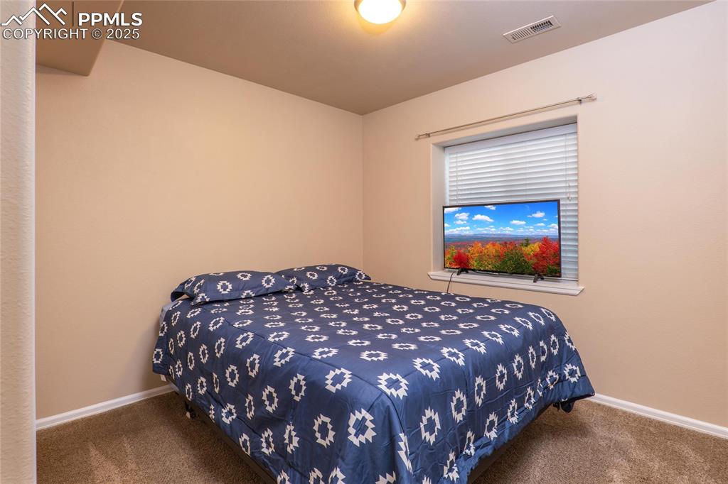 Image 20 of 25: Basement bedroom.