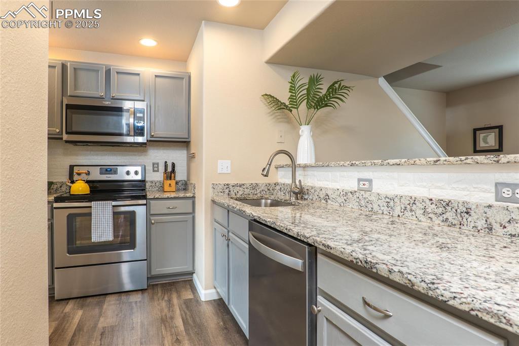 Image 3 of 25: Granite counters, Farmhouse Sink, SS Appliances and LVP Flooring.
