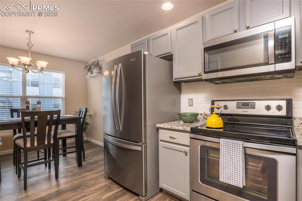 Image 5 of 25: Kitchen opens to the dining area.