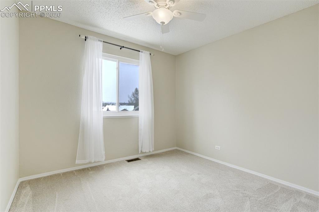 Image 29 of 46: Bedroom 2 is bright & functional.