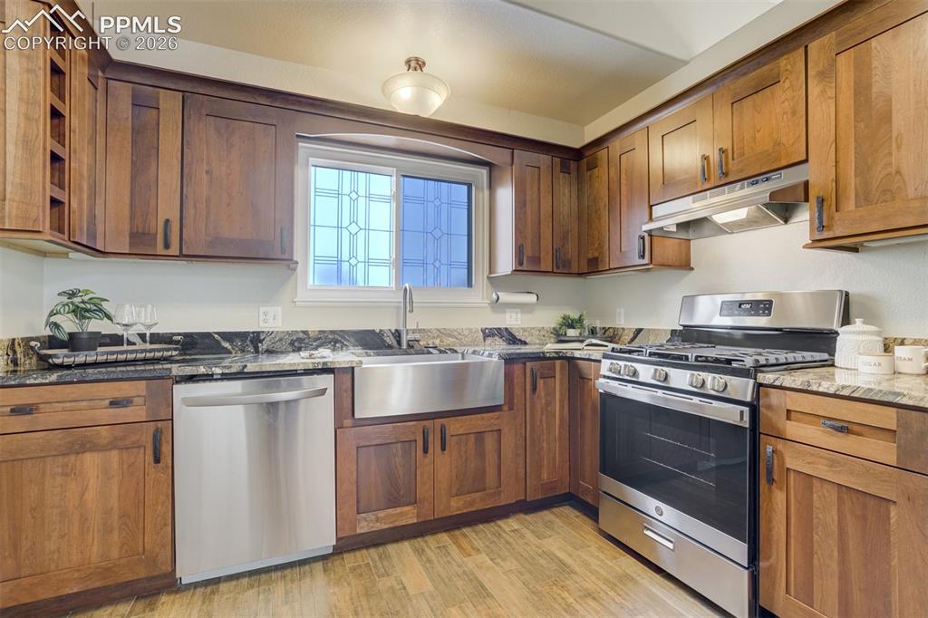 Image 9 of 46: his remodeled kitchen understood the assignment: custom granite, custom cab