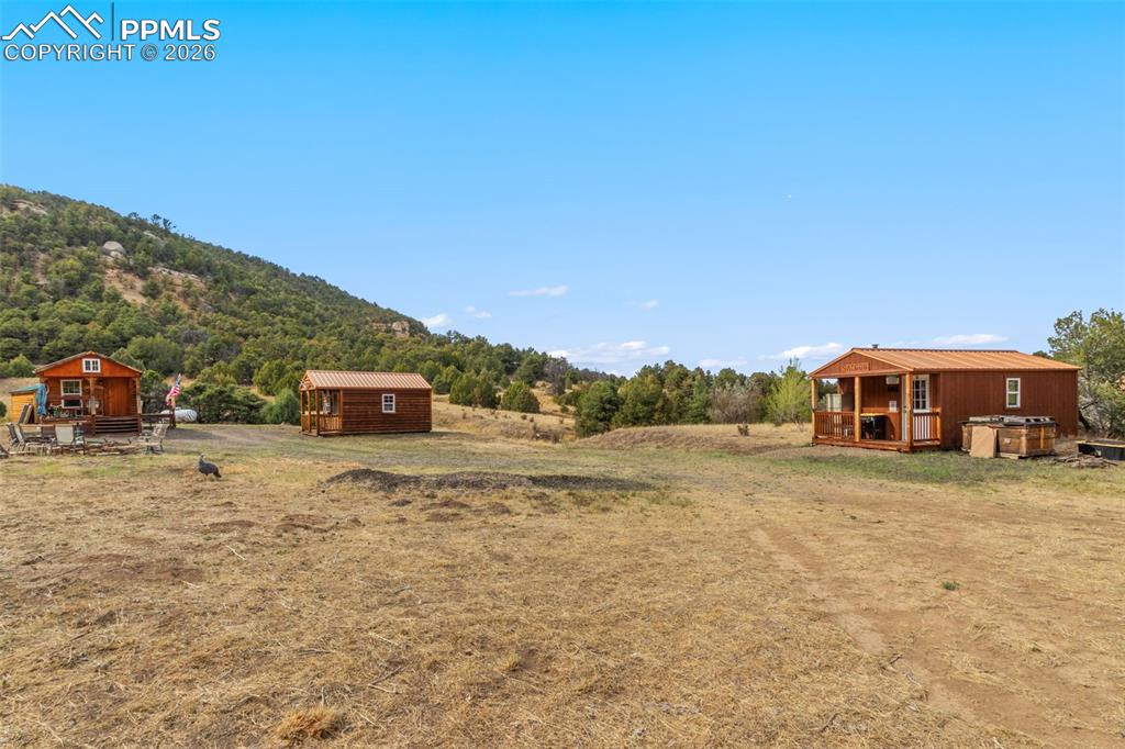 Image 2 of 50: From left to right...log cabin, bunkhouse cabin, and saloon cabin.
