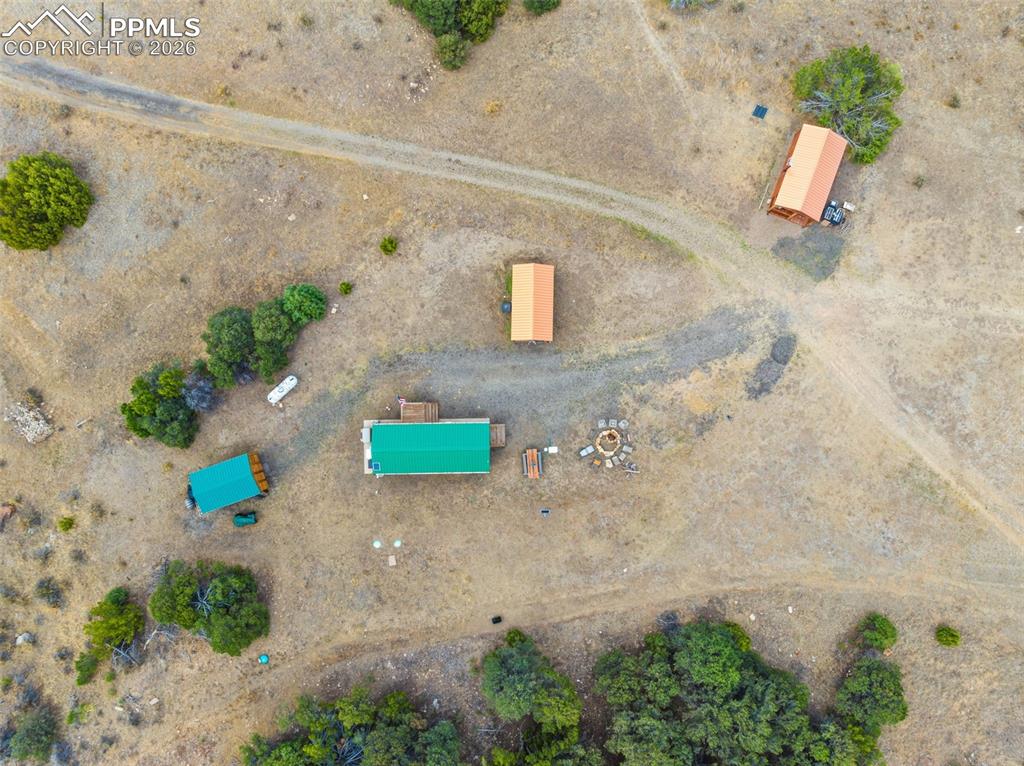 Image 7 of 50: Buildings from left to right...storage shed, log cabin, bunkhouse cabin, an