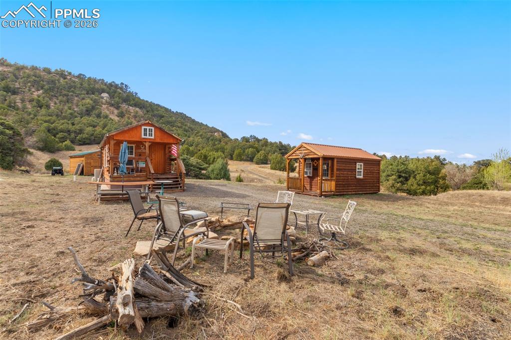 Image 8 of 50: From left to right...log cabin and bunkhouse cabin.