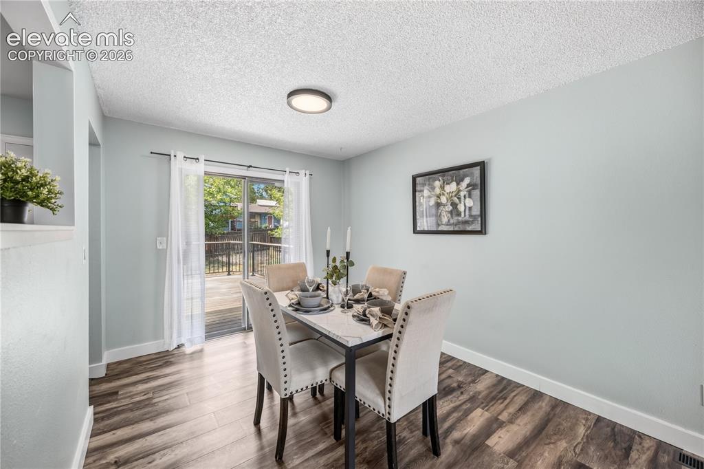 Image 9 of 32: open dining area that overlooks the backyard