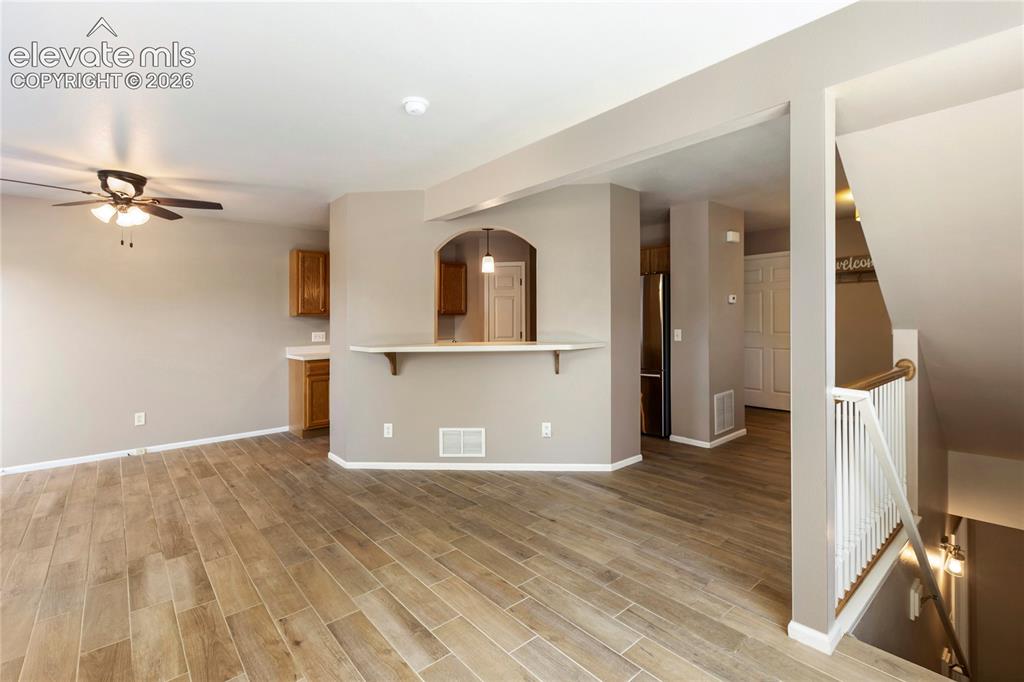 Image 17 of 48: New floors and stacked stone on fireplace. Walks out to back deck-looking t