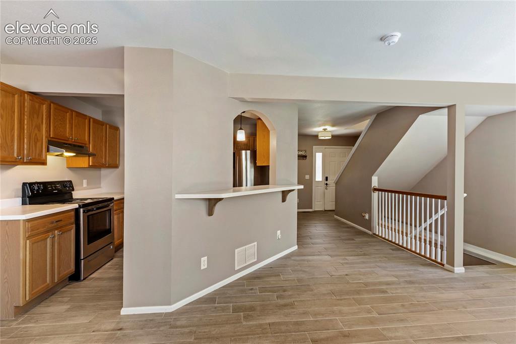 Image 21 of 48: Beautiful open floor plan. Kitchen open on both sides.