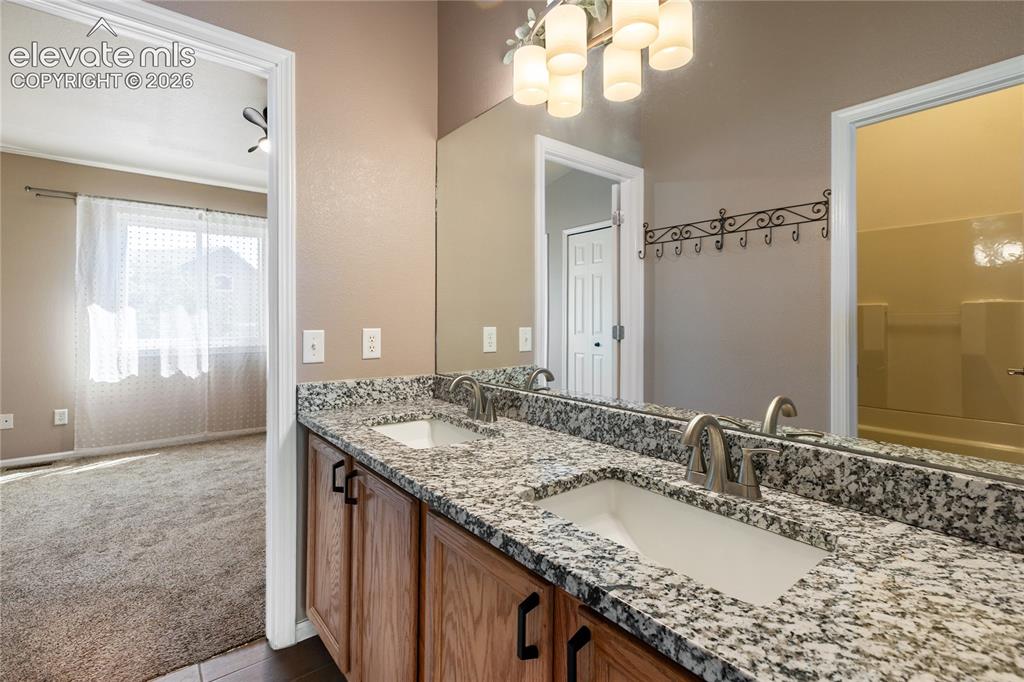 Image 32 of 48: Double vanity, natural light, new granite countertop upstairs bathroom.