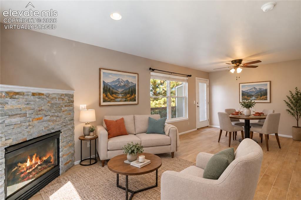 Image 4 of 48: Virtually Staged-New floors and stacked stone on fireplace. Walks out to ba