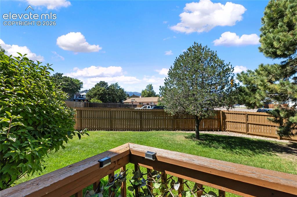 Image 48 of 48: Looking off back deck large grass area, and mtn views. 