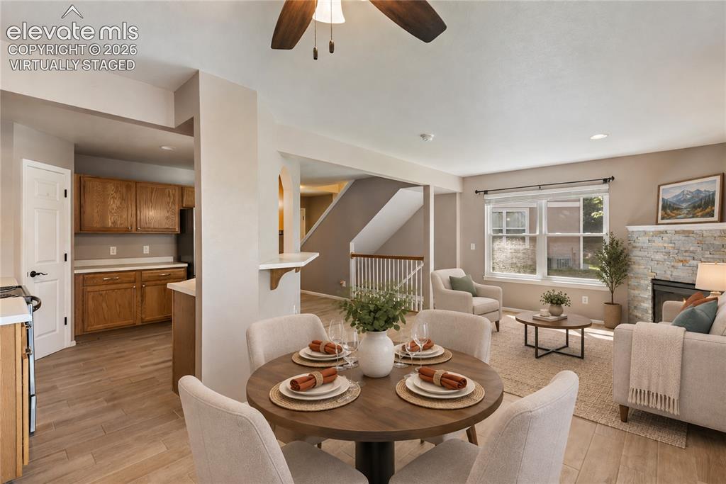 Image 6 of 48: Virtually Staged-New floors and stacked stone on fireplace. Walks out to ba