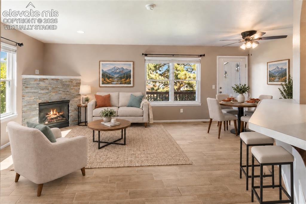 Image 7 of 48: Virtually Staged-New floors and stacked stone on fireplace. Walks out to ba