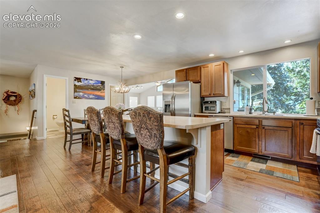 Image 10 of 50: Kitchen featuring wood-finish flooring, recessed lighting, wood cabinetry, 