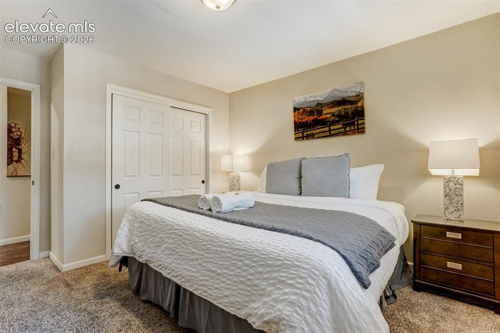 Image 24 of 50: Recessed ceiling light fixture, carpeted flooring, sliding closet doors, an