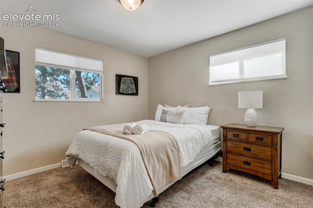 Image 25 of 50: Light-toned walls complement plush carpeting
