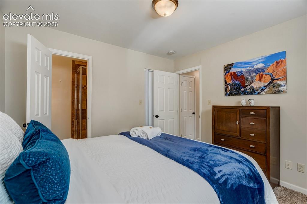 Image 28 of 50: Neutral wall colors, recessed ceiling light, and ample natural light