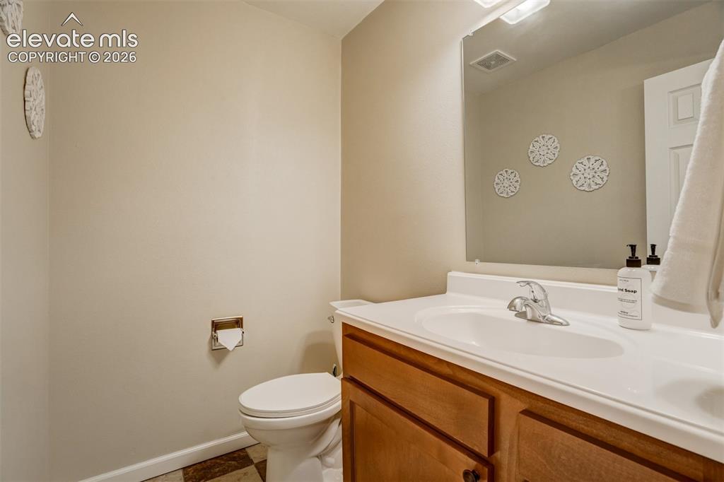 Image 42 of 50: Integrated sink and countertop, wood-finish vanity with cabinet storage, wa