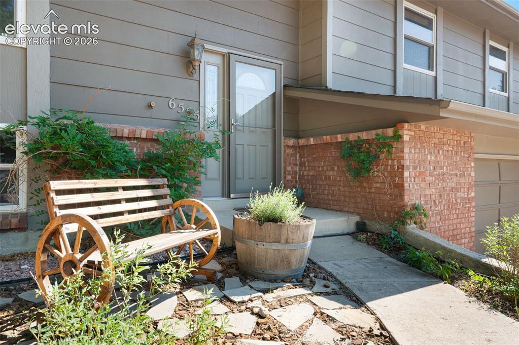 Image 3 of 44: Beautiful landscaping at front of home