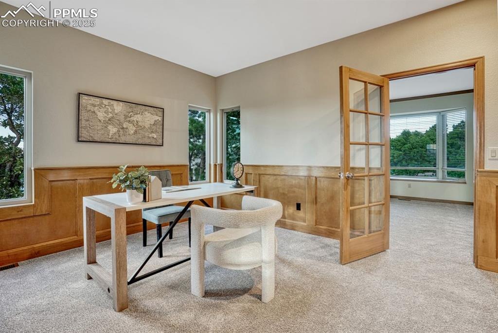 Image 11 of 43: Home office or library with natural light coming from all sides
