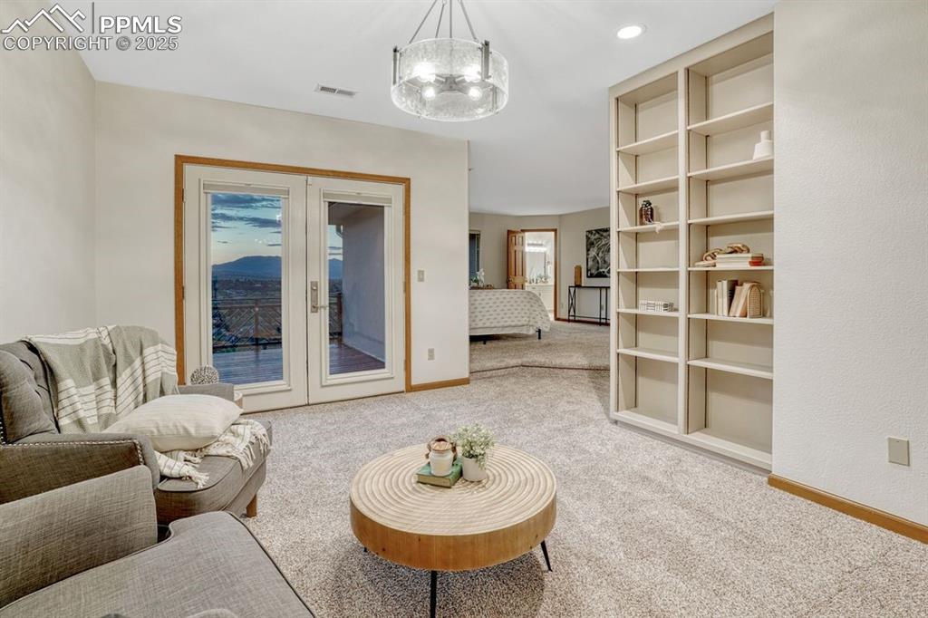 Image 20 of 43: The great escape from it all! A sunken sitting room with bookshelves, new l