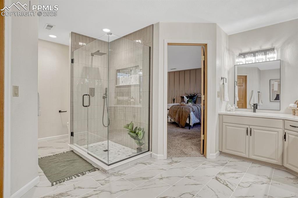 Image 23 of 43: Ensuite with glass walled shower, decorative tile & new lighting