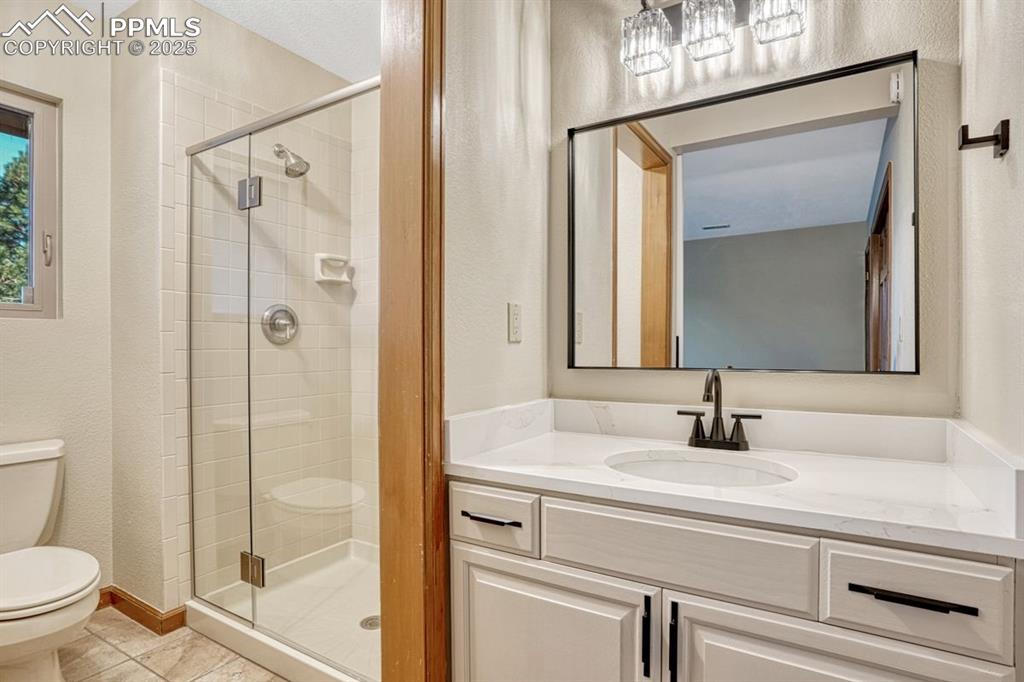 Image 26 of 43: Private bath with new lighting, new vanity and hardware