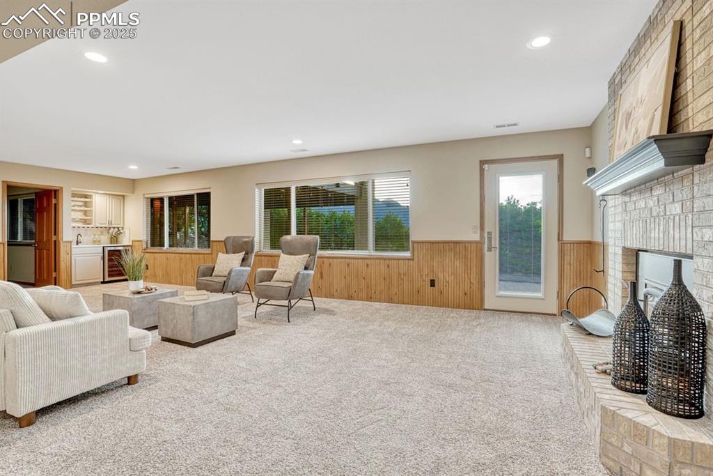 Image 31 of 43: Downstairs great room with wet bar, fireplace and walkout