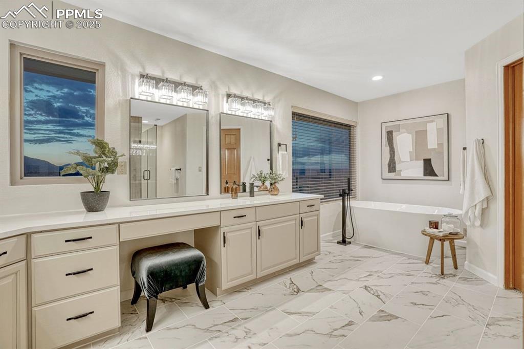 Image 6 of 43: Primary bath with new lighting, and plenty of natural light