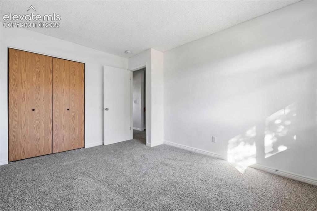 Image 18 of 27: Light grey textured carpeting