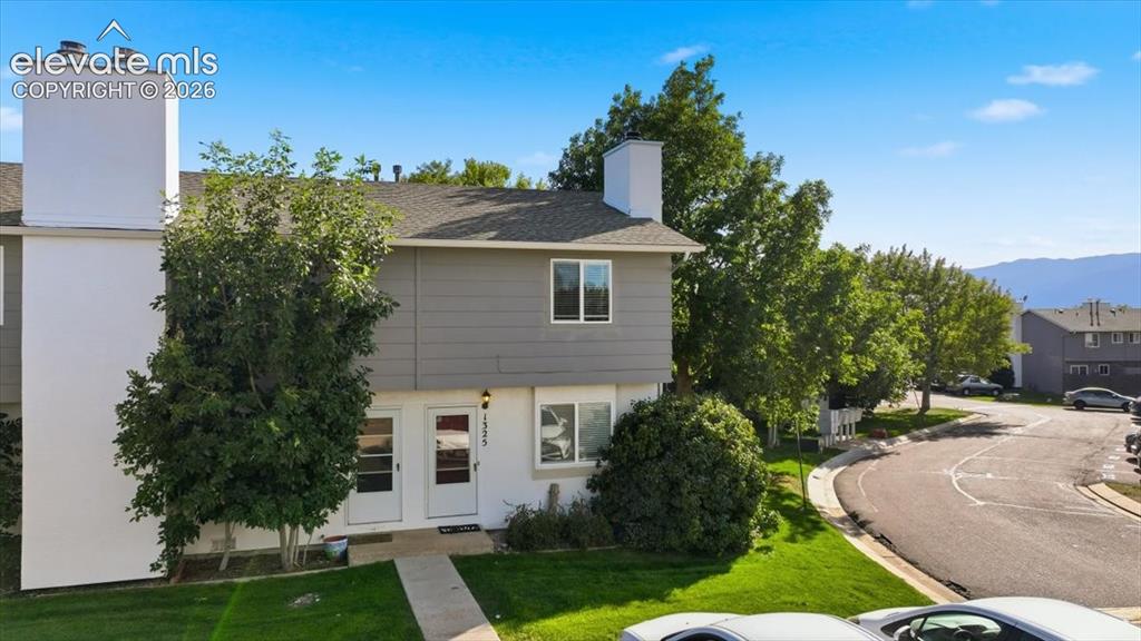 Image 3 of 27: Two-story exterior with a gray siding upper level and white lower level, fe