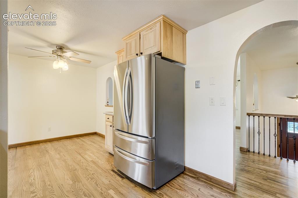 Image 16 of 50: Dining Area off the Kitchen. Natural Oak Wood Floors flow throughout the m