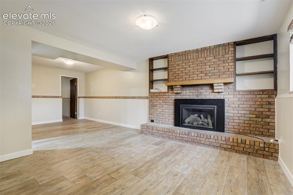 Image 23 of 50: Original Brick Fireplace wall with Gas fireplace insert