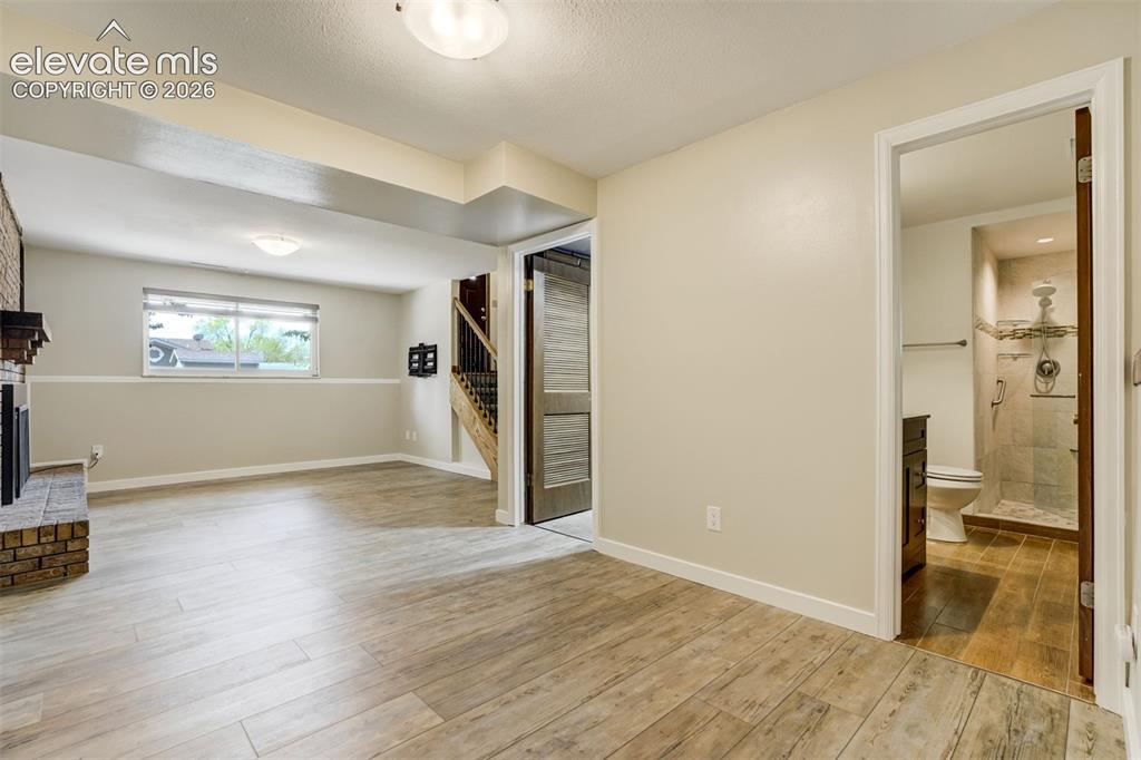 Image 24 of 50: Family Room in Garden Level Basement with 3/4 Bath