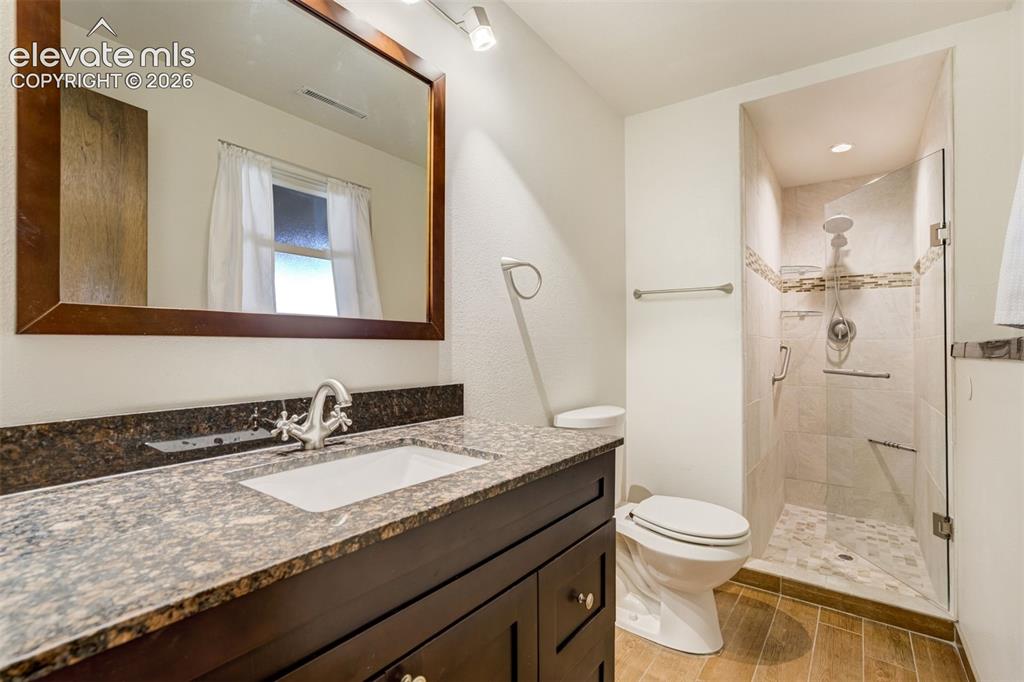 Image 34 of 50: Updated Basement 3/4 Bath with beautiful custom tile design in walk in show