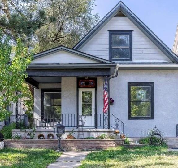 Image 1 of 9: Bungalow-style house featuring covered porch and stucco siding