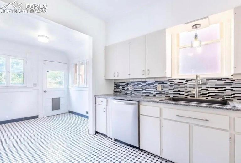 Image 4 of 9: Kitchen featuring tasteful backsplash, dishwasher, white cabinets, and pend