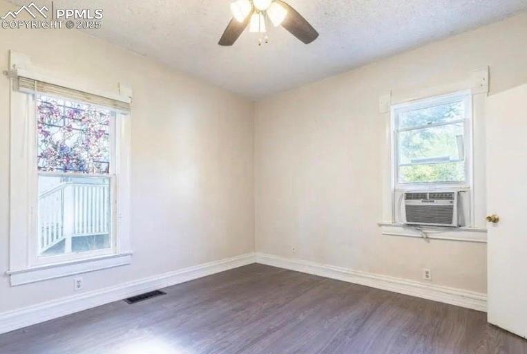 Image 8 of 9: Empty room featuring dark wood-style floors, a ceiling fan, a textured ceil