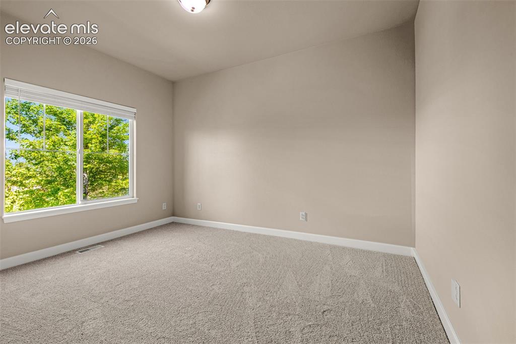 Image 12 of 39: Behind the Fireplace is a private Office with views of the mountains and ma