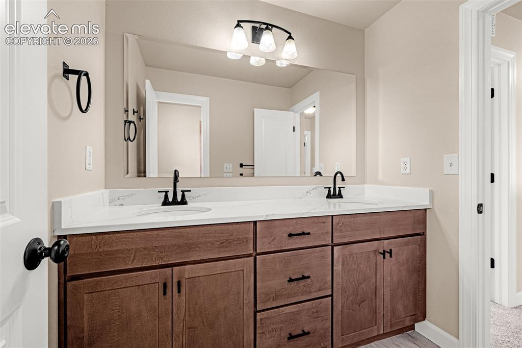 Image 19 of 39: Fully remodeled bathroom.  New cabinets, flooring, lights, fixtures.  