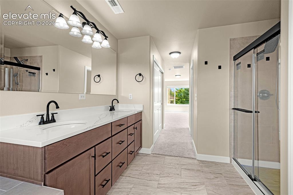 Image 27 of 39: Another view of the Primary Bathroom. Oversized walk-in shower, dual sinks