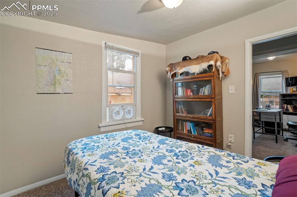 Image 13 of 24: Carpeted bedroom with baseboards and a ceiling fan