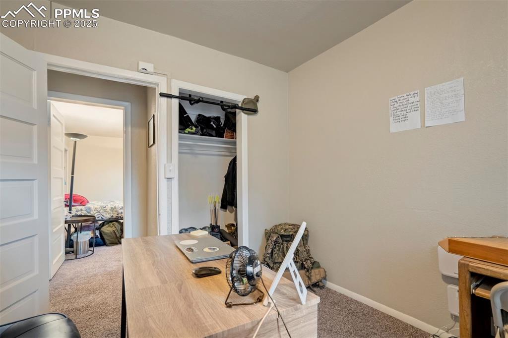 Image 17 of 24: Carpeted office space featuring baseboards